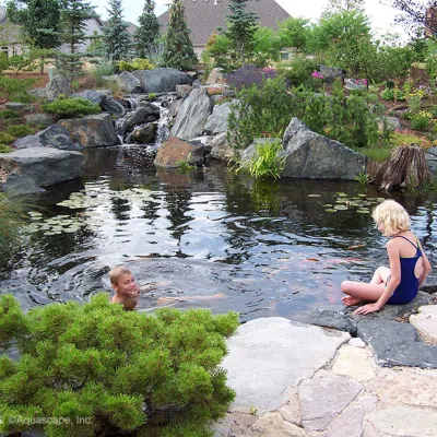 Children swimming in the pond